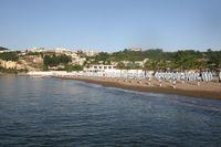 Low coast with volcanic rocks on the background. Source: https://lidonapoli.it