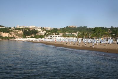 Low coast with volcanic rocks on the background. Source: https://lidonapoli.it