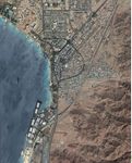 An aerial view of Aqaba city showing the Red Sea as the blue infrastructure and the green infrastructure can only be seen in the median island in the main streets and also it can be seen along the shoreline, specifically in front of the main entrances of the resorts to create an inviting landscaped entrance for the guests.